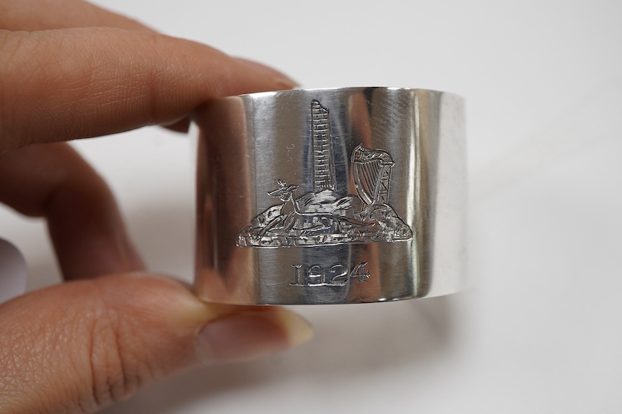 A cased set of six George V Irish silver napkin ring's, each engraved with a dear and harp on a rocky mound with tower and dated 1924, Wakely & Wheeler, Dublin, 1923.